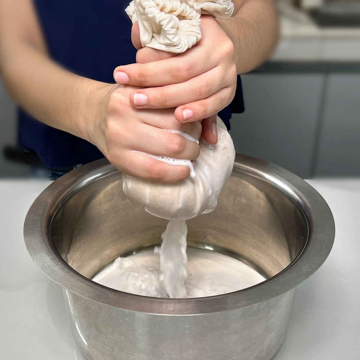 Sieving nut milk with Organic Cotton Nut Milk Bag - eco-friendly, reusable, and effective liquid strainer