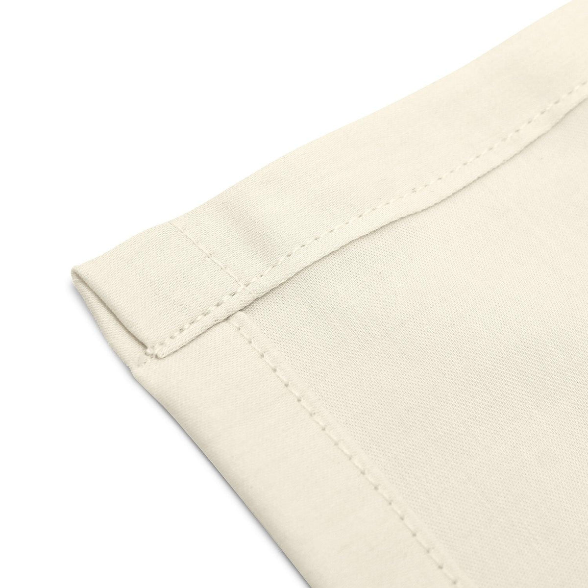 Close-up of neatly stitched corners of an organic cotton handkerchief for women, 12x12 inches, cream white.