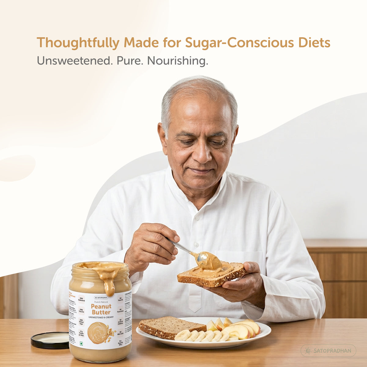 Satopradhan unsweetened peanut butter served with wholegrain toast and fruit as a simple snack option for sugar-conscious diets.